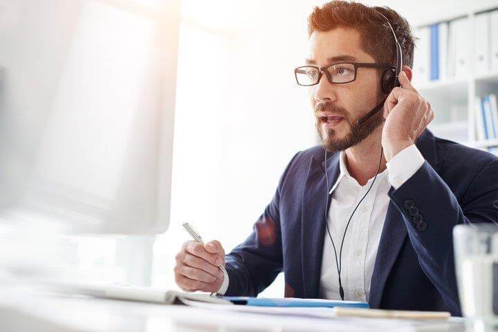 man using telephone microphone to communicate