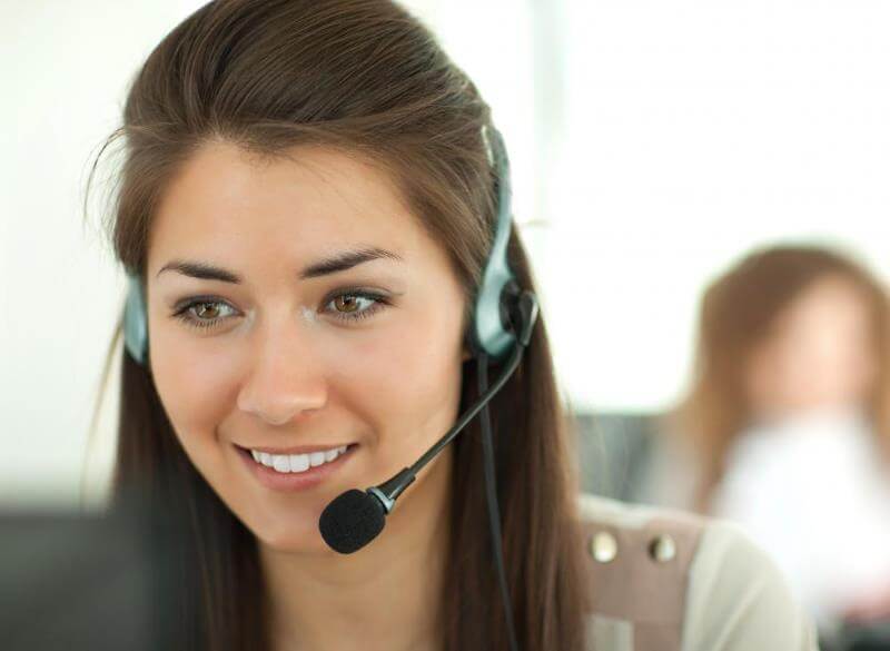 woman using telephone microphone to communicate