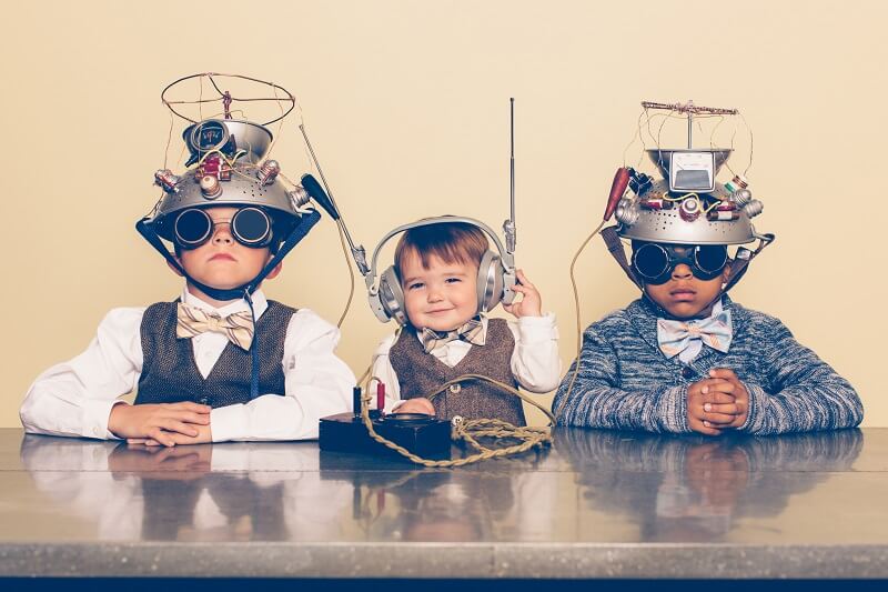 children wearing headset at dinner table 