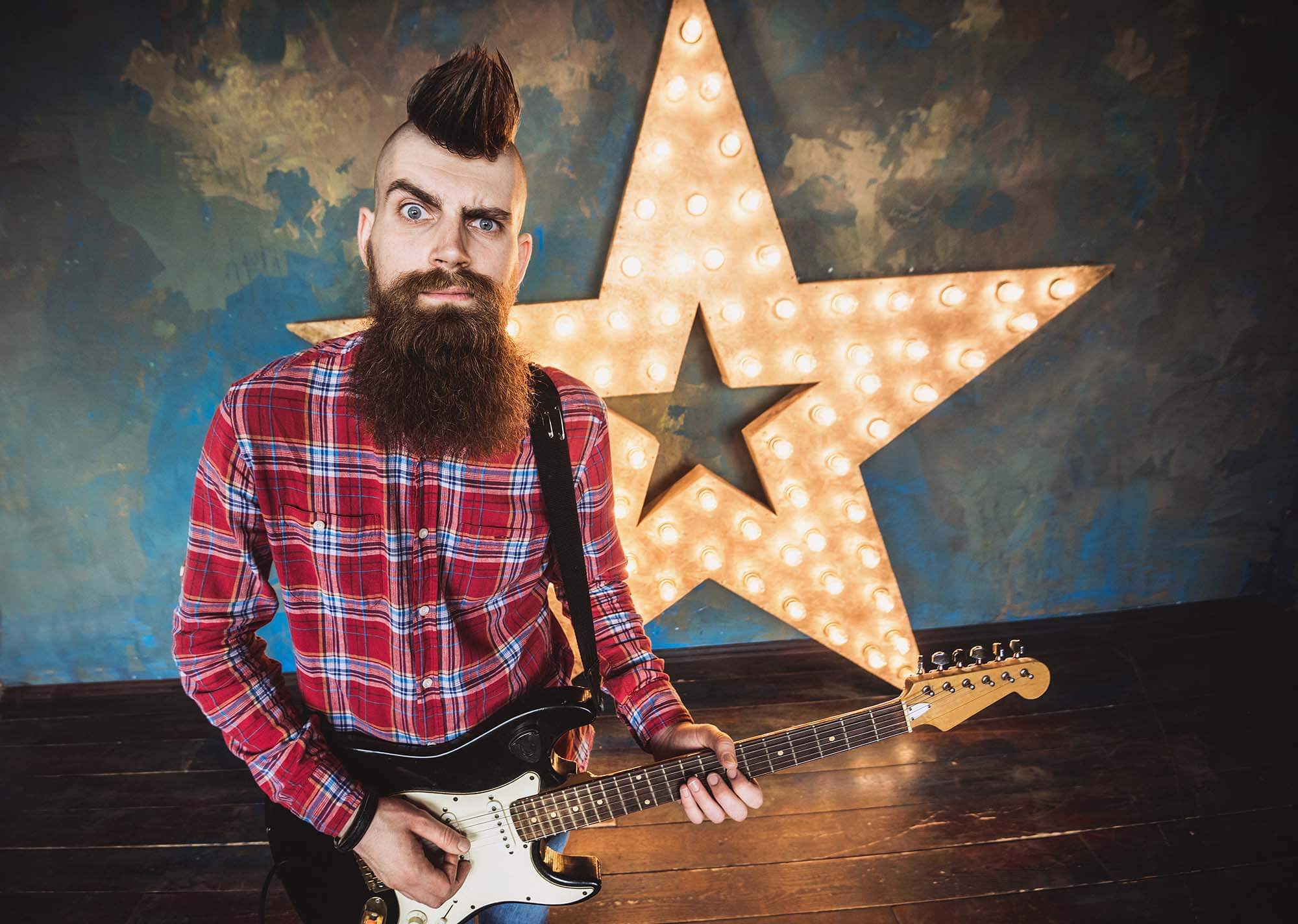 man dressed in short in front of a light up star