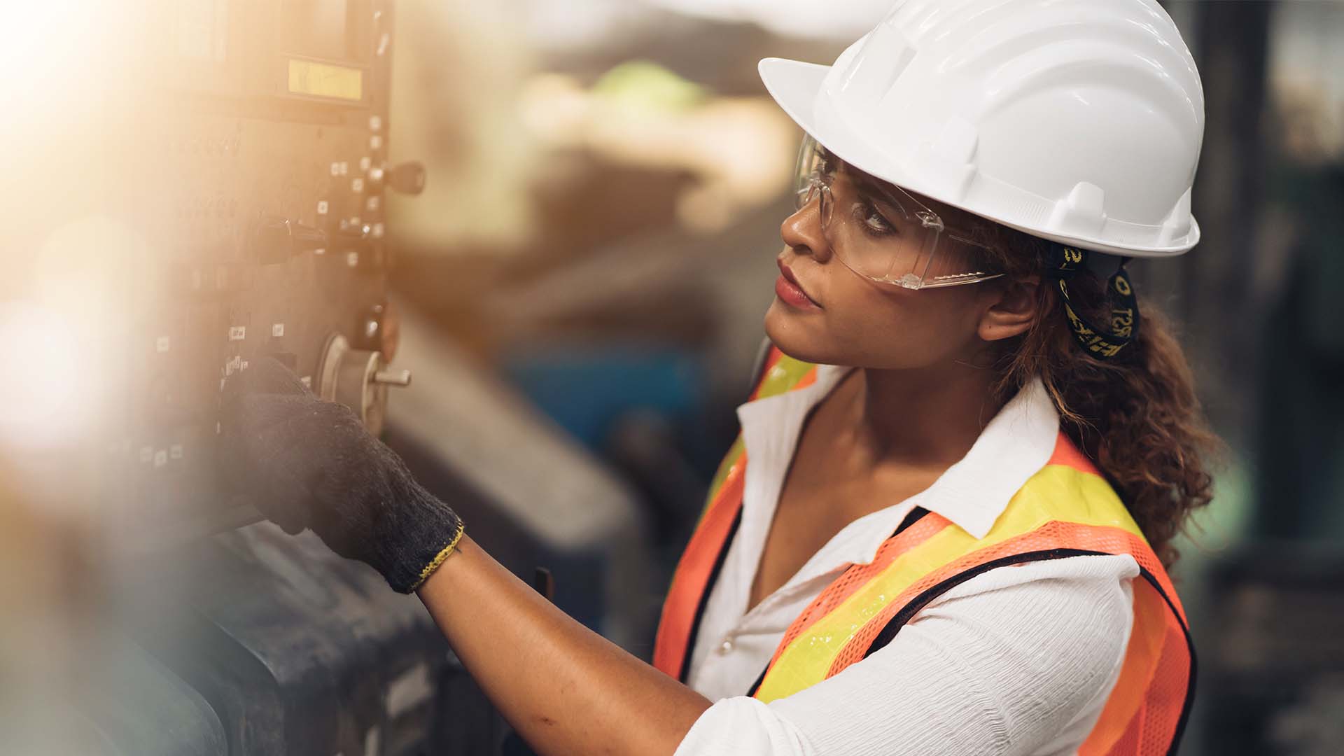 female construction worker looking at equipment