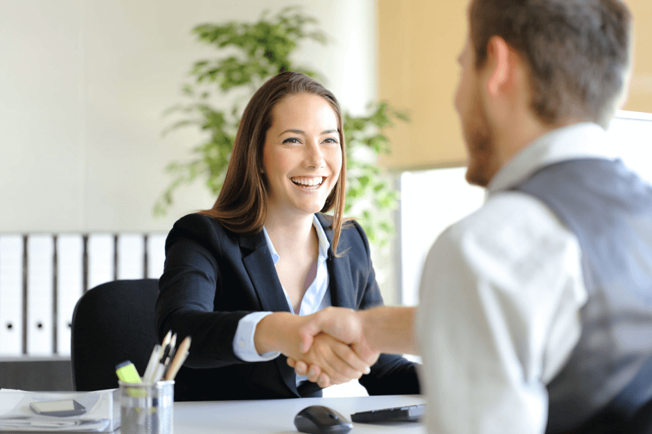 man and woman shaking hands during a job interview