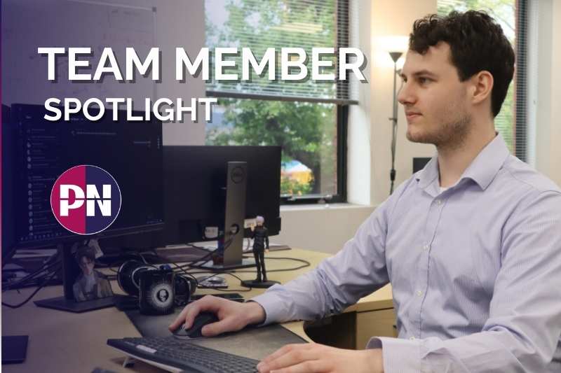 Image of team member with PN logo at their desk.