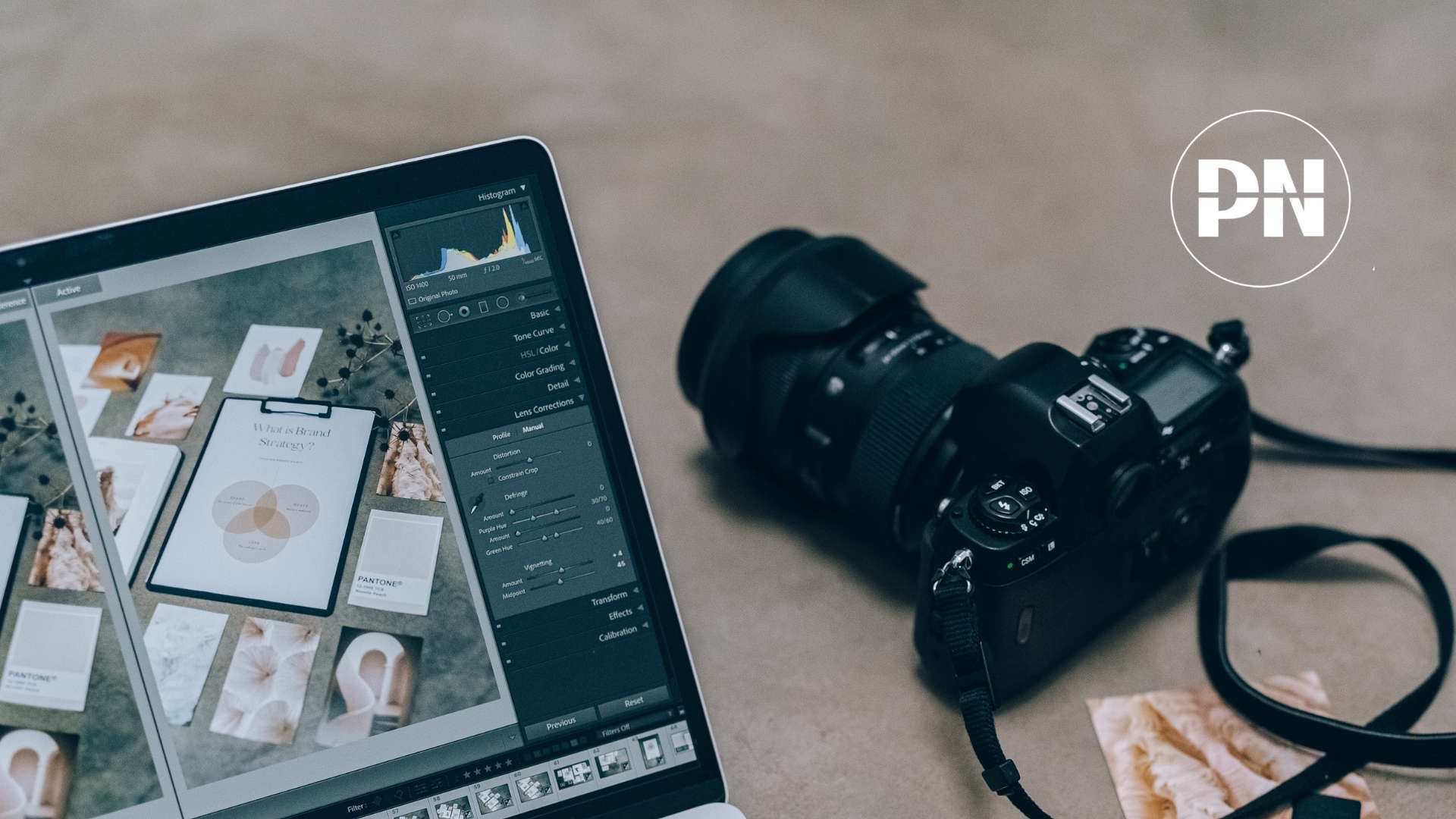 A laptop with video editing software next to a camera